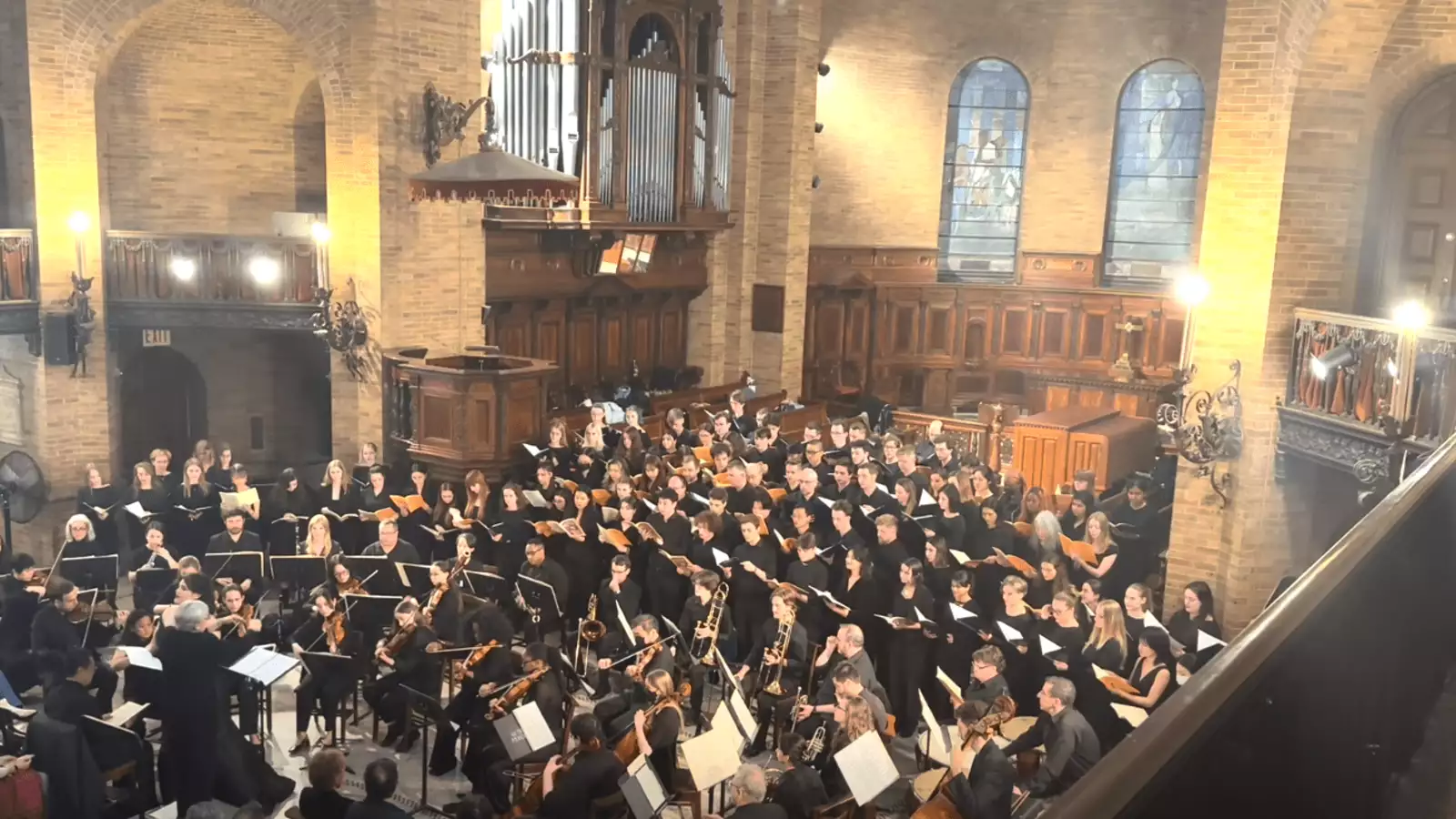 Choir singers performing in chapel.